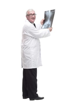 full-length. qualified mature doctor looking at the x-ray. isolated on a white background.