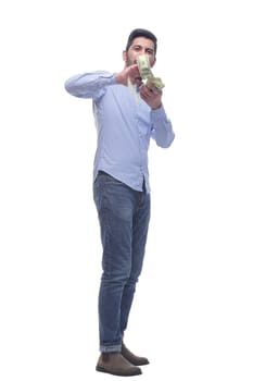 in full growth. happy man with a fan of dollar bills . isolated on a white background.
