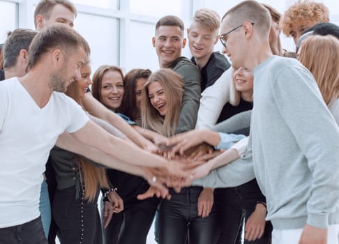 close up. a group of young people making a tower out of their hands.