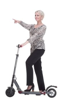 side view. elegant young woman with an electric scooter looking at you . isolated on a white background.
