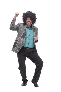 in full growth. cheerful man in a curly wig. isolated on a white background.