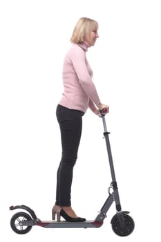 Beautiful woman riding an electric scooter isolated on white background and looking at camera and smiling