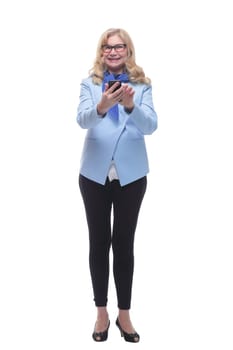 in full growth. smiling adult woman with a smartphone . isolated on a white background.