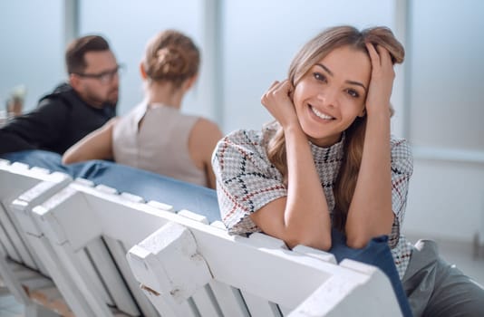 young business woman sitting in office lobby at coffee break. office weekdays