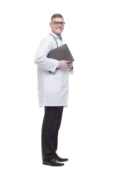 in full growth. young doctor with a clipboard. isolated on a white background.