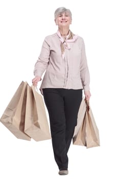 in full growth. smiling old lady with shopping bags . isolated on a white background.
