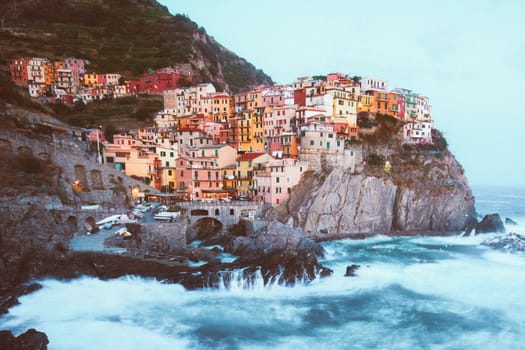Manarola fisherman village in a dramatic wind storm. Manarola is one of five famous villages of Cinque Terre, suspended between sea and land on sheer cliffs upon the wild waves.