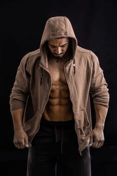 A shirtless man in a brown jacket