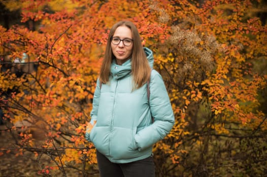 Autumn portrait of beautiful woman on fall nature background