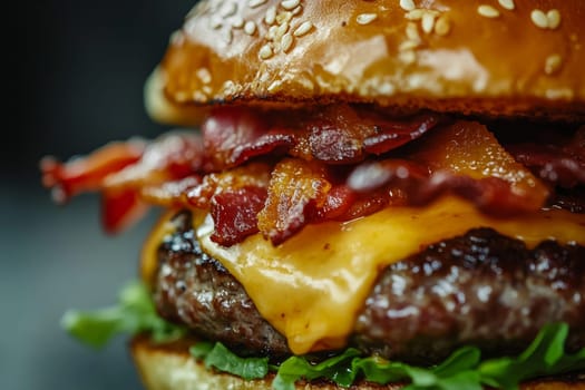 Close up of a juicy cheeseburger with melted cheese, crispy bacon, and sesame seed bun.