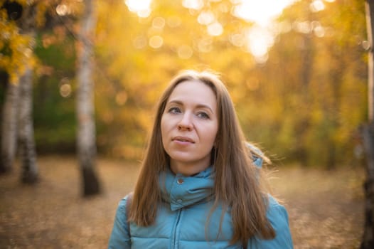 Autumn portrait of beautiful woman on fall nature background