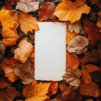 A rectangular piece of blank paper lies among colorful autumn leaves, creating a cozy and inviting atmosphere.