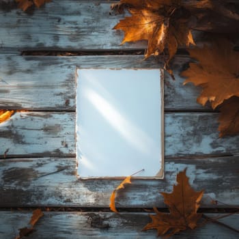 A blank notepad rests on a weathered wooden surface, accompanied by vibrant autumn leaves in warm afternoon sunlight.