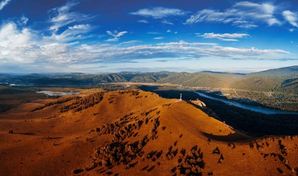 Aerial autumn panorama drone shot of beauty dawn on the peak, in the mountains in Altay, summertime