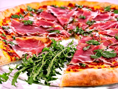 Prosciutto and Arugula Pizza with thin slices of prosciutto and peppery arugula served. Food isolated on transparent background.