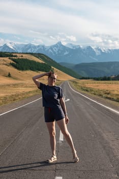 Woman om the Chuysky trakt road in the Altai mountains. One of the most beautiful road in the world.