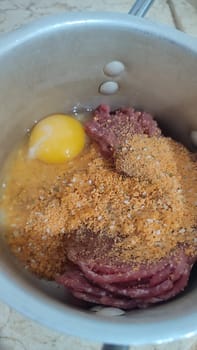 raw meat and, egg, breadcrumbs mixture for cutlets food cooking lunch dinner. High quality photo