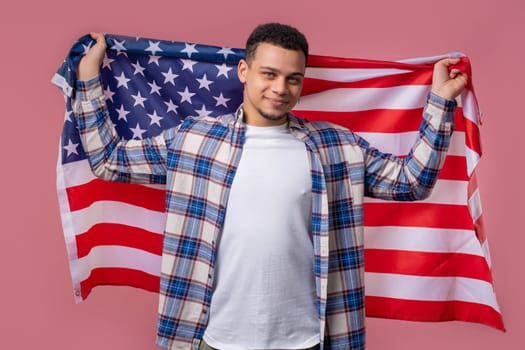 Happy man with national USA flag on pink background. American patriot, 4th of July - Independence day celebration, election, America, labor. US banner. High quality