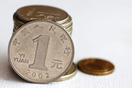 1 yuan coin close-up, other coins on a light background.