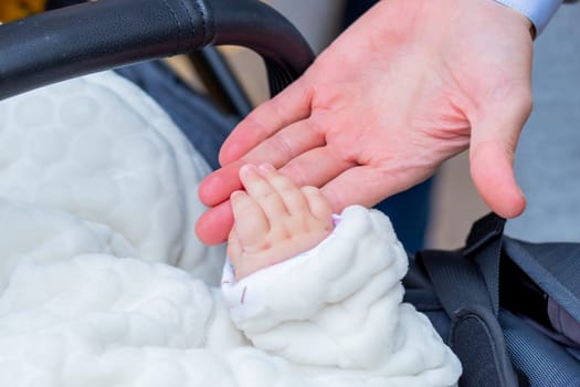 Children's hands with care, concern, warmth of mother and father.
