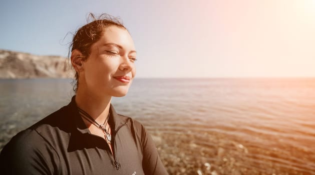 Woman travel sea. Young Happy woman posing on a beach near the sea on background of volcanic rocks, like in Iceland, sharing travel adventure journey