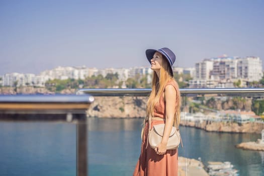 Happy woman tourist on background of old street of Antalya. female tourist traveler discover interesting places and popular attractions and walks in the old city Kalechi of Antalya, Turkey. Turkiye.