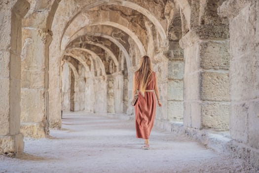 Woman tourist explores Aspendos Ancient City. Aspendos acropolis city ruins, cisterns, aqueducts and old temple. Aspendos Antalya Turkey. turkiye.
