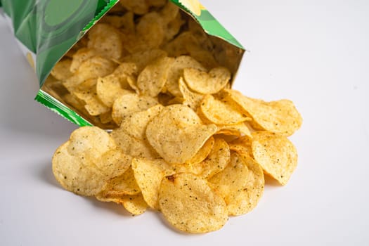 Potato chips, delicious spicy for crips, thin slice deep fried snack fast food in open bag.