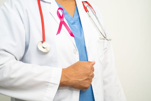 Breast cancer, Asian doctor woman with pink ribbon, symbol of World Breast Cancer Day.