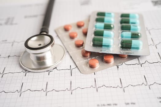 Stethoscope on electrocardiogram ECG with capsule drug, heart wave, heart attack, cardiogram report.