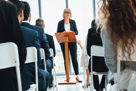 Group of business people meeting in a seminar conference . Audience listening to instructor in employee education training session . Office worker community summit forum with expert speaker . Jivy