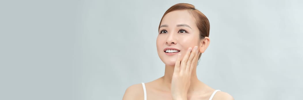 Banner with happy Asian female face with natural skin on white background