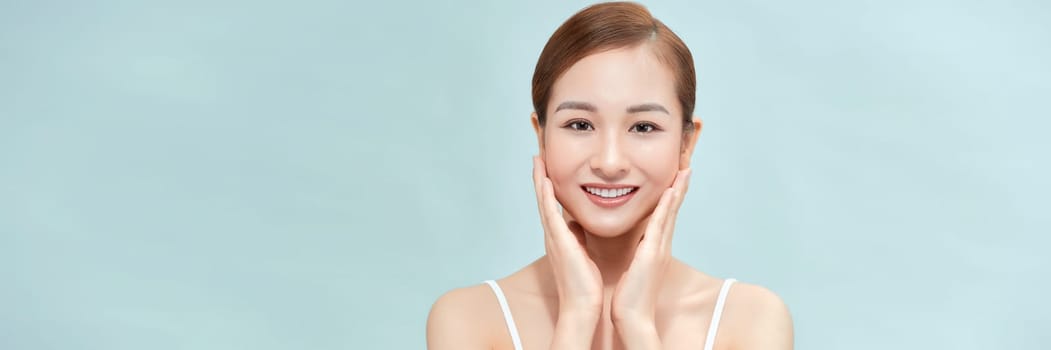 A smiling woman clean fresh face isolated on pastel background, banner