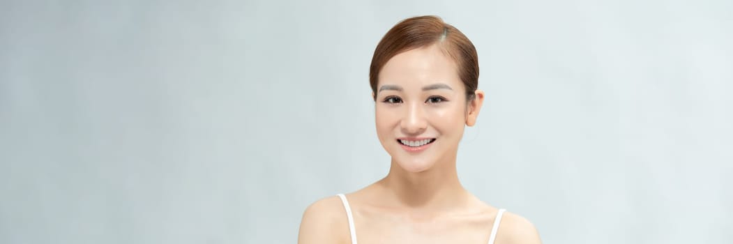 Banner with happy Asian female face with natural skin on white background