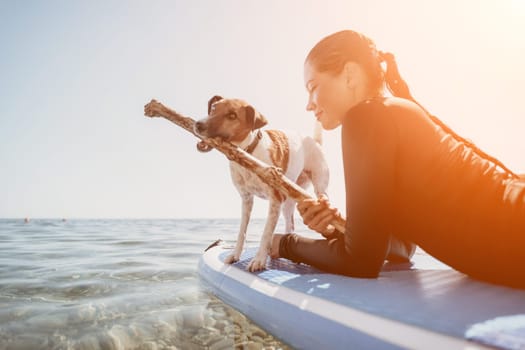 Sea woman sup. A happy positive woman in hat with family relaxing in sea, aerial back view of family on SUP board floating on calm water. Active lifestyle at sea. Summer vacation. Slow motion
