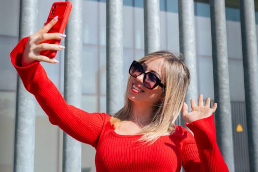 Happy young woman taking a selfie with smartphone.