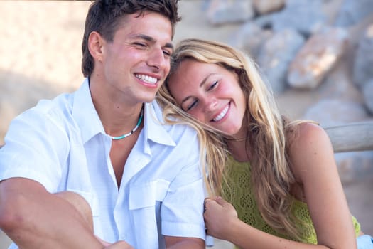 Smiling multiethnic woman and man enjoying vacation. Beautiful and cheerful couple of generation z pose for a photo with a mobile phone.