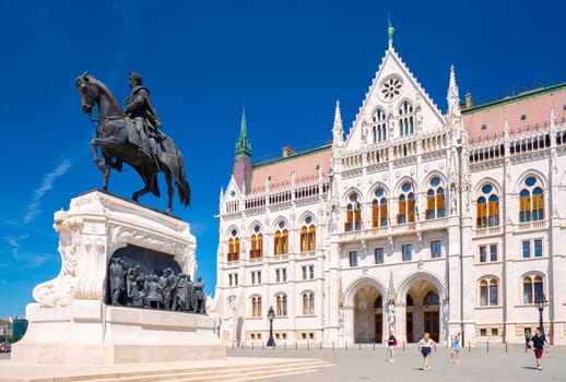 Budapest, Hungary - 5 April 2024: Statue of Count Gyula Andrássy and the Library of the Hungarian Parliament