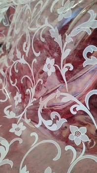 white lace fabric on a red background, floral pattern. High quality photo