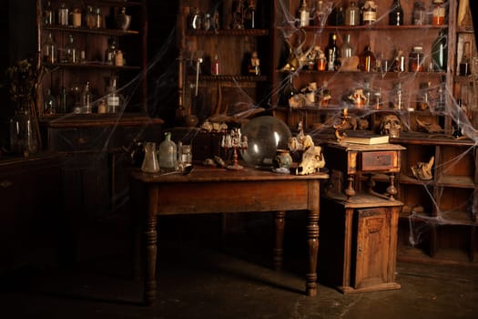Halloween background Shelves with alchemy tools Skull spiderweb bottle with poison candles Witcher workspace Scarry room