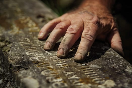 Hand Touching Engraved Headstone, Symbol of Time and Remembrance, Contemplating Memories.
