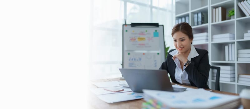 woman plans a finance and budget audit by reviewing organizing office financial documents.