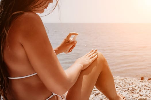 Woman sunscreen sea. Close up of happy smiling woman is applying sunscreen or sun tanning lotion on body to take care of her skin on seaside beach. Female On Sea Vacation Holiday Resort. Slow motion