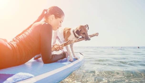 Sea woman sup. A happy positive woman in hat with family relaxing in sea, aerial back view of family on SUP board floating on calm water. Active lifestyle at sea. Summer vacation. Slow motion