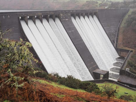 Water in full spate flowing from Meldon Reservoir over Meldon Dam on the West Okement River, Dartmoor National Park, Devon, UK