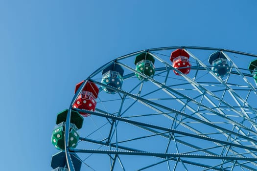 Helsinki, Finland - 19 AUGUST 2024: Linnanmaki amusement park. Ferris wheel Rinkeli, blue sky on a background