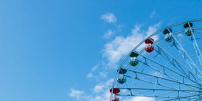 Helsinki, Finland - 19 AUGUST 2024: Linnanmaki amusement park. Ferris wheel Rinkeli, blue sky on a background
