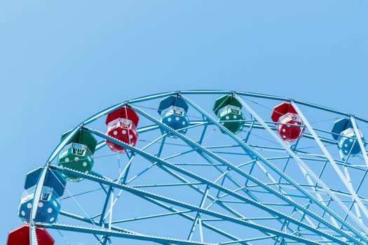 Helsinki, Finland - 19 AUGUST 2024: Linnanmaki amusement park. Ferris wheel Rinkeli, blue sky on a background