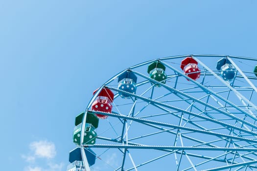 Helsinki, Finland - 19 AUGUST 2024: Linnanmaki amusement park. Ferris wheel Rinkeli, blue sky on a background