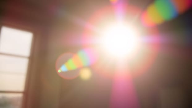 Light pours from a warm, bright rainbow in blur on a black background with a dusty texture. Use this defocused, abstract, damaged, scratched, retro cinema analog effect as a screen filter or overlay for image. High quality photo
